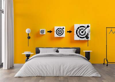 Setting business goals. Developing goals and objectives. Growing target symbols on white cubes on yellow background. Wall mural