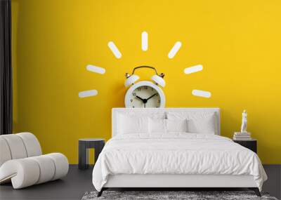 White retro alarm clock ringing on yellow background. Wall mural