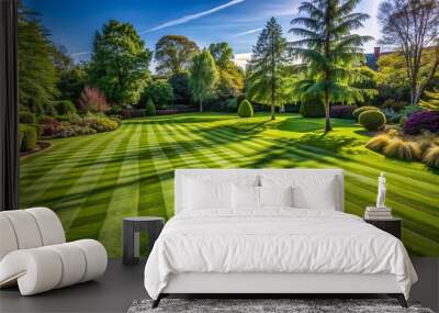 Emerald green lawn with freshly mowed grass striped in neat patterns and slight shadows under a sunny sky. Wall mural