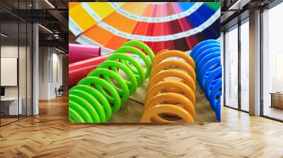 metal, car spring parts coated with powder coating and color chart on wooden background Wall mural