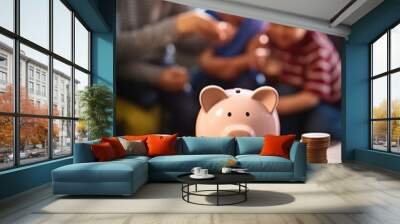 hand placing money into a piggy bank. concept of family savings and how to invest in the future with Wall mural