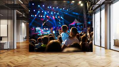 Concert seen from the crowds with a young boy and his father watching the performance Wall mural