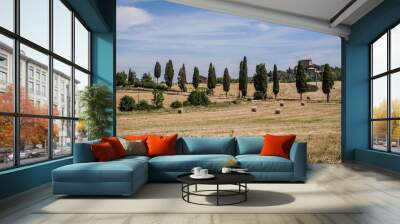 TUSCANY-JUNE 2: Hay bales and cypress trees of Orcia Valley,Tuscany,Italy,on June 2,2017. Wall mural