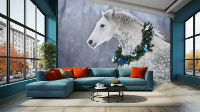 White horse with christmas wreath isolated on black background Wall mural