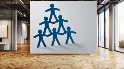 Human pyramid of paper cut-out people on white background - Concept of teamwork Wall mural