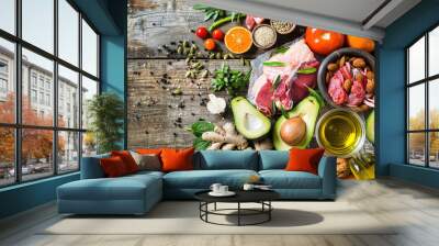 Various healthy foods, such as colorful fresh vegetables and fruit with meat or fish, arranged on the table. Wall mural