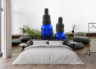 bottle of aromatherapy oil and fresh green leaves Wall mural