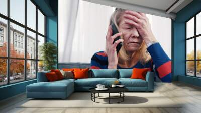 Desperate old woman having phone conversation with tears. High quality photo Wall mural