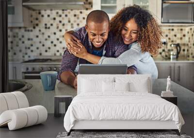 Check this out. Cropped shot of an affectionate young couple using a tablet in their kitchen at home. Wall mural