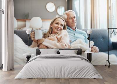 Coffee, couch, comfortability and you is all I need. Cropped shot of a mature couple relaxing on the sofa at home. Wall mural