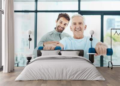 Hes putting in the effort for a healthier life. Shot of a friendly physiotherapist helping his senior patient work out with weights. Wall mural