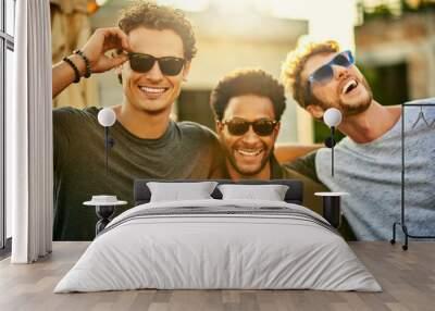 Killing it in the shades game. Shot of a group of young men hanging out together outdoors. Wall mural