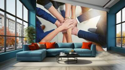 Making business better together. Closeup shot of a group of businesspeople joining their hands together in unity. Wall mural