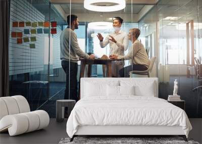 Quick meeting before lunch. Shot of businesspeople having a meeting in the office. Wall mural