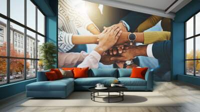 Together as one is how well win. Closeup shot of an unrecognizable group of businesspeople joining their hands together in a huddle. Wall mural