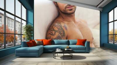 Taking some me time.... Portrait of a bare-chested young man sitting on a sofa. Wall mural