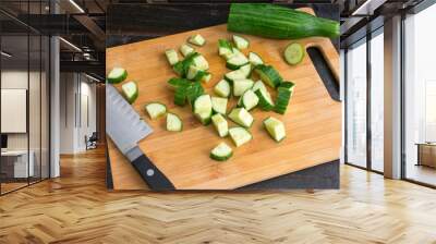 Chopping a Seedless Cucumber: Cutting an English cucumber into chunks on a bamboo cutting board Wall mural