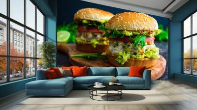 Shrimp Burgers with Cilantro and Guacamole on Sesame Seed Buns: Seafood hamburger sandwiches made topped with guacamole and sliced tomato Wall mural