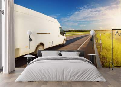 asphalt road on dandelion field with a small truck Wall mural