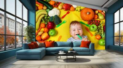 Baby surrounded with fruits and vegetables Wall mural