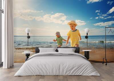 Boy and girl playing on the beach Wall mural