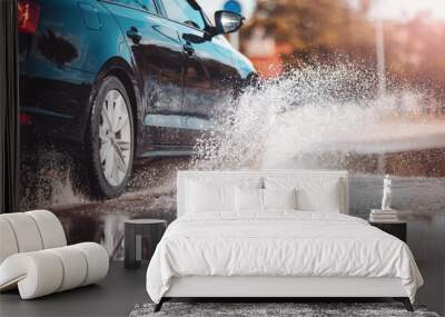 Car driving through the puddle and splashing by water. Wall mural