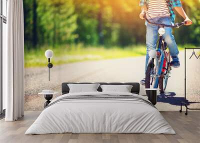 child on a bicycle at asphalt road in early morning Wall mural