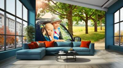 Children looking out of window from a car Wall mural