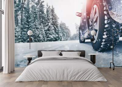 Closeup of car tires in winter on the road covered with snow Wall mural