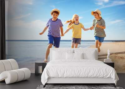 Cute children running along the sea coast Wall mural