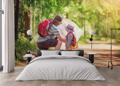 Father and boy going camping with tent in nature Wall mural