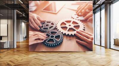 Group of people working in the office while putting together cogwheels. Wall mural