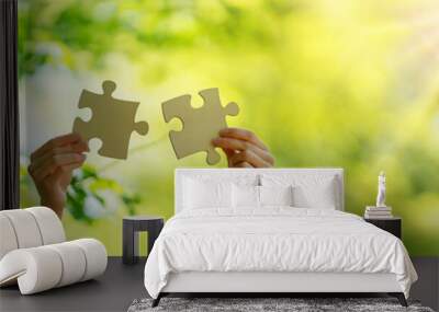 Human hand with piece of jigsaw outdoors on the nature background. Wall mural