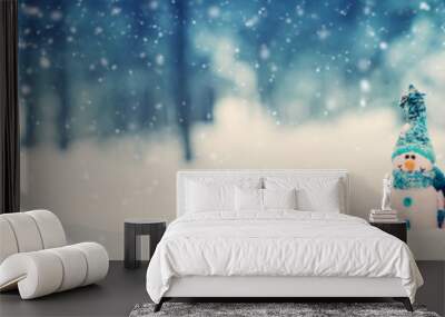 little knitted snowmans on soft snow on blue background Wall mural