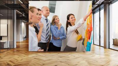 Businesswoman Pointing Labels On Whiteboard Wall mural