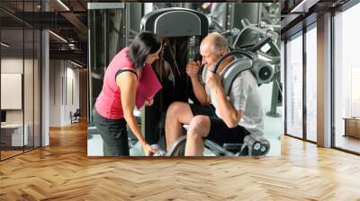 Mature man exercising with personal trainer Wall mural