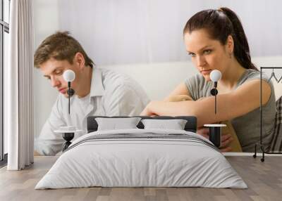 Unhappy couple sitting silently after argument Wall mural