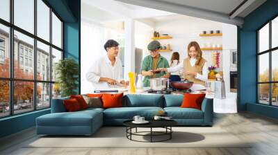 Group of Diversity Asian people cooking healthy food pasta and salad for celebration dinner party together in the kitchen. Cheerful man and woman friend enjoy reunion meeting event on holiday vacation Wall mural