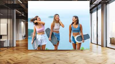 Group of Healthy Asian woman skater skating and hiking to mountain peak at tropical island on summer travel vacation. Female friends enjoy outdoor activity lifestyle adventure extreme sport together Wall mural