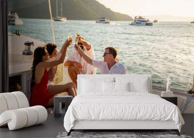 group of man and woman friends enjoy party drinking champagne with talking together while catamaran  Wall mural