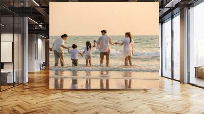 Happy multi generation Asian family holding hands and having fun together on tropical beach in summertime. Smiling big family parents with child boy and girl enjoy in summer lifestyle travel vacation Wall mural