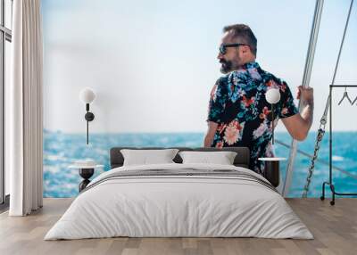 Portrait of Caucasian man enjoy luxury lifestyle catamaran boat sailing with looking at beautiful nature sea at summer sunset. Handsome male relaxing outdoor activity on tropical travel vacation trip Wall mural