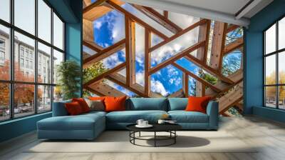 Geometric windows made of wood and blue cloudy sky. Wall mural