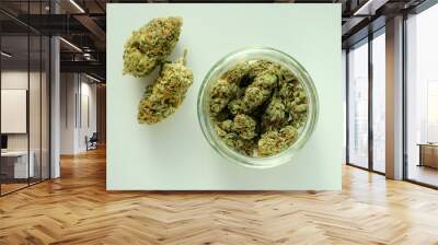 Marijuana product, trimmed buds in a jar. Medicinal cannabis stuff isolated on white background. CBD recreation, medical usage, pastime therapy. Wall mural