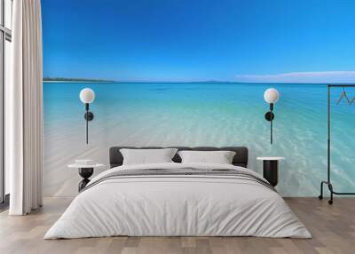 Pristine beach with clear blue water and white sand Wall mural