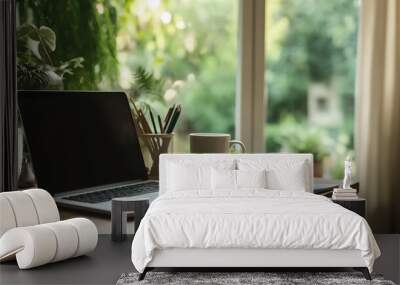 A stylish home office setup with a laptop, coffee cup, and notepad on a wooden desk Wall mural