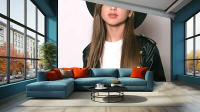 A teenage girl in a trendy leather jacket and an even hat on a white background. Teenage fashion. Street fashion. Beauty and fashion
 Wall mural