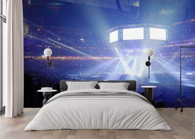 Concert stage with shining lights and crowd at a performance. Rock music event at a stadium with colorful spotlights and projectors. Wall mural