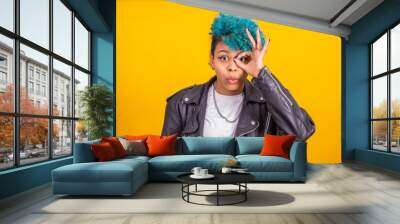 afro american girl with blue curly hair isolated on yellow background Wall mural