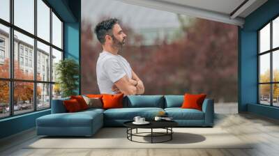 attractive young adult man with beard outdoors, in profile with copy-space Wall mural